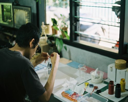 Freelancer working on a laptop at a bright desk in Bandung